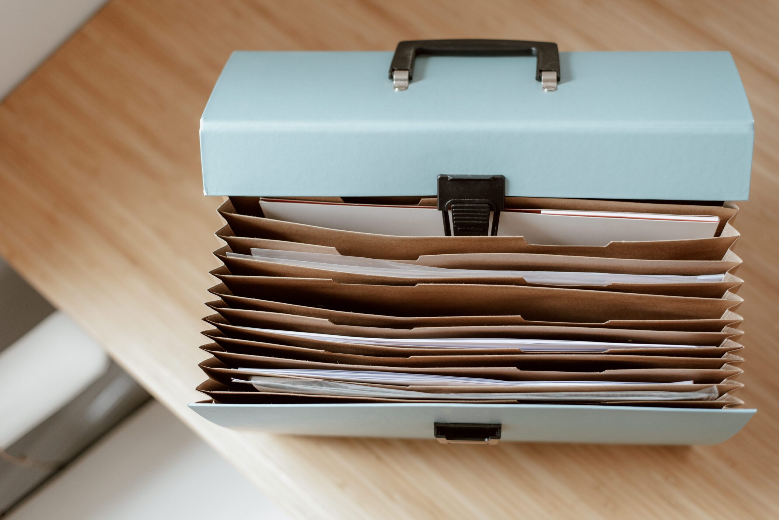 Accordion folder organizing documents, representing tidy record-keeping